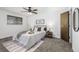 Bright bedroom with a queen-size bed and ceiling fan at 7915 Chase Cir # 156, Arvada, CO 80003