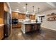 Kitchen with island, stainless steel appliances, and light wood cabinets at 16479 Golden Sun, Monument, CO 80132