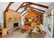 Living room with brick fireplace and wood beams at 6685 E Exposition Ave, Denver, CO 80224