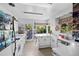 Retro kitchen with white cabinetry and garden views at 6685 E Exposition Ave, Denver, CO 80224