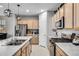 Modern kitchen with stainless steel appliances and light wood cabinets at 9804 Truckee St, Commerce City, CO 80022