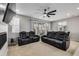Relaxing living room featuring a ceiling fan and sliding glass doors at 9804 Truckee St, Commerce City, CO 80022