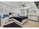 Bright bedroom with a large bed, dresser, and ceiling fan at 9804 Truckee St, Commerce City, CO 80022