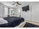 Main bedroom with large bed, dresser, TV and ceiling fan at 9804 Truckee St, Commerce City, CO 80022