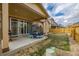 Fenced backyard with patio, grass, and a trampoline at 9804 Truckee St, Commerce City, CO 80022