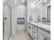 Bright bathroom with double vanity, shower, and updated fixtures at 9804 Truckee St, Commerce City, CO 80022