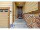 Front entry with dark brown door and stone accents at 9804 Truckee St, Commerce City, CO 80022