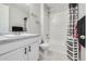 Clean bathroom with tub shower, vanity, and neutral tones at 9804 Truckee St, Commerce City, CO 80022