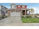 Two-story red home with stone accents and attached garage at 1109 Larkspur Dr, Erie, CO 80516