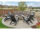 Stone fire pit surrounded by comfortable seating in a backyard at 1109 Larkspur Dr, Erie, CO 80516