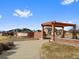 Community entrance with pergola and landscaping at 25584 E Byers Dr, Aurora, CO 80018