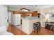 Kitchen with breakfast bar and wood cabinets at 13761 E Lehigh Ave # E, Aurora, CO 80014