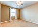 Bright bedroom with neutral walls, ceiling fan, and carpet flooring at 7005 S Fultondale Cir, Aurora, CO 80016