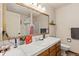 Bathroom with vanity, large mirror, and wood cabinets at 1749 Foster Dr, Longmont, CO 80501