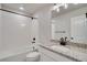 Clean bathroom with white tiled walls, granite countertop, and a bathtub at 954 Plum Creek Ct, Brighton, CO 80601