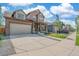 Two-story house with attached garage and landscaping at 954 Plum Creek Ct, Brighton, CO 80601