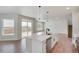 Modern kitchen with island, stainless steel appliances, and backyard view at 954 Plum Creek Ct, Brighton, CO 80601