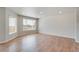 Bright living room featuring hardwood floors and large windows at 954 Plum Creek Ct, Brighton, CO 80601