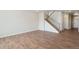 Spacious living room with hardwood floors and staircase at 954 Plum Creek Ct, Brighton, CO 80601