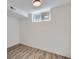 Bright, finished basement room with wood-look flooring and a window at 3612 Forest St, Denver, CO 80207