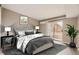 Spacious main bedroom with plush bedding and access to balcony at 5745 W Atlantic Pl # 206, Lakewood, CO 80227