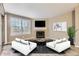 Living room with corner fireplace and staged furniture at 5745 W Atlantic Pl # 206, Lakewood, CO 80227