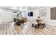 Dining area with a wooden table and white chairs adjacent to the living room at 125 Mesa Way, Superior, CO 80027