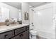 Clean bathroom with tub, toilet, and dark brown vanity at 125 Mesa Way, Superior, CO 80027