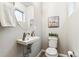 Small bathroom with toilet, sink, and oval mirror at 125 Mesa Way, Superior, CO 80027