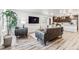 Open concept living area with gray couches, a large TV, and hardwood floors at 125 Mesa Way, Superior, CO 80027