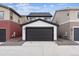 Attached garage with dark gray door and gravel driveway at 125 Mesa Way, Superior, CO 80027