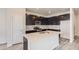 Modern kitchen featuring dark cabinetry, quartz countertops, and stainless steel appliances at 14063 Deertrack Ln, Parker, CO 80134