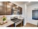 Dark brown kitchen cabinets and stainless steel range at 4326 Canyata Dr, Elizabeth, CO 80107