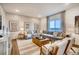 Spacious living room with large windows, gray sectional sofa, and wooden coffee table at 4326 Canyata Dr, Elizabeth, CO 80107