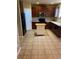 Kitchen with dark wood cabinets, black appliances, and an island at 4764 S Duquesne St, Aurora, CO 80016