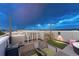 Modern rooftop deck features a table, chairs, and a small artificial lawn at 1245 Utica St # 105, Denver, CO 80204