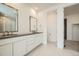 Modern bathroom with double vanity and walk-in shower at 1090 Sunrise Dr, Erie, CO 80516