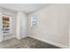 Bright bedroom with carpet, window, and closet at 4422 Lincoln St, Denver, CO 80216