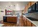 Kitchen with wood cabinets, a large island, stainless steel appliances, and an adjacent dining area at 10967 Bellbrook Cir, Highlands Ranch, CO 80130