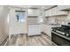 Modern kitchen with white cabinets and stainless steel appliances at 7321 Carnation Pl, Commerce City, CO 80022