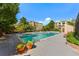 Community swimming pool with lounge chairs and landscaping at 7000 E Quincy Ave # 204, Denver, CO 80237