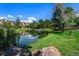 Serene pond with reflection of buildings and sky at 7000 E Quincy Ave # 204, Denver, CO 80237