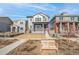 Two-story home with gray siding, red door and attached two-car garage at 21284 E 63Rd Dr, Aurora, CO 80019