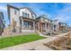 Row of townhouses with varying siding colors and front porches at 21284 E 63Rd Dr, Aurora, CO 80019