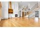 Vaulted living room with hardwood floors, fireplace, and large windows at 1199 Links Ct, Erie, CO 80516