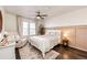 Cozy bedroom with neutral decor, ceiling fan, and plush armchair at 1786 Quartz St, Castle Rock, CO 80109