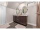 Double vanity bathroom with large mirrors and updated fixtures at 1468 S Washington St, Denver, CO 80210