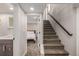 Basement stairs leading to finished lower level bedroom and bath at 1468 S Washington St, Denver, CO 80210