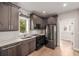 Modern kitchen with dark cabinets, stainless steel appliances, and quartz countertops at 1468 S Washington St, Denver, CO 80210