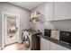 Laundry room with washer, dryer, and built-in shelving at 1468 S Washington St, Denver, CO 80210